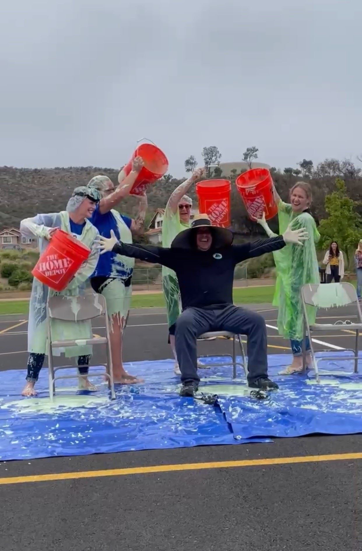 Some teacher pouring slime over the school custodian.